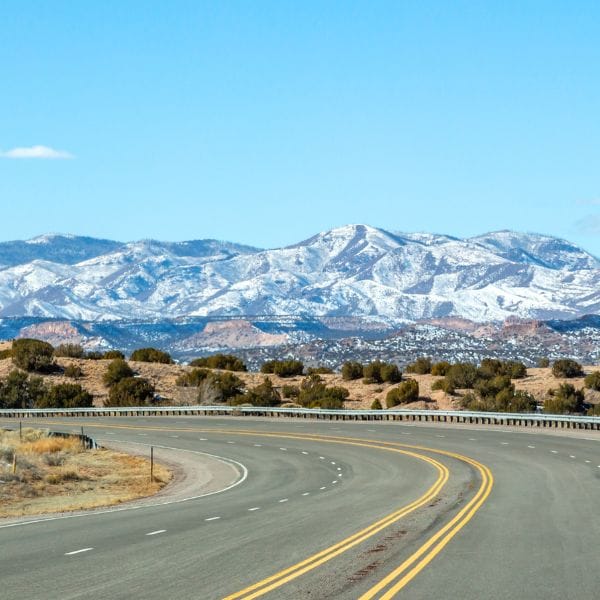 Snow-capped mountains and highway near Los Alamo, New Mexico